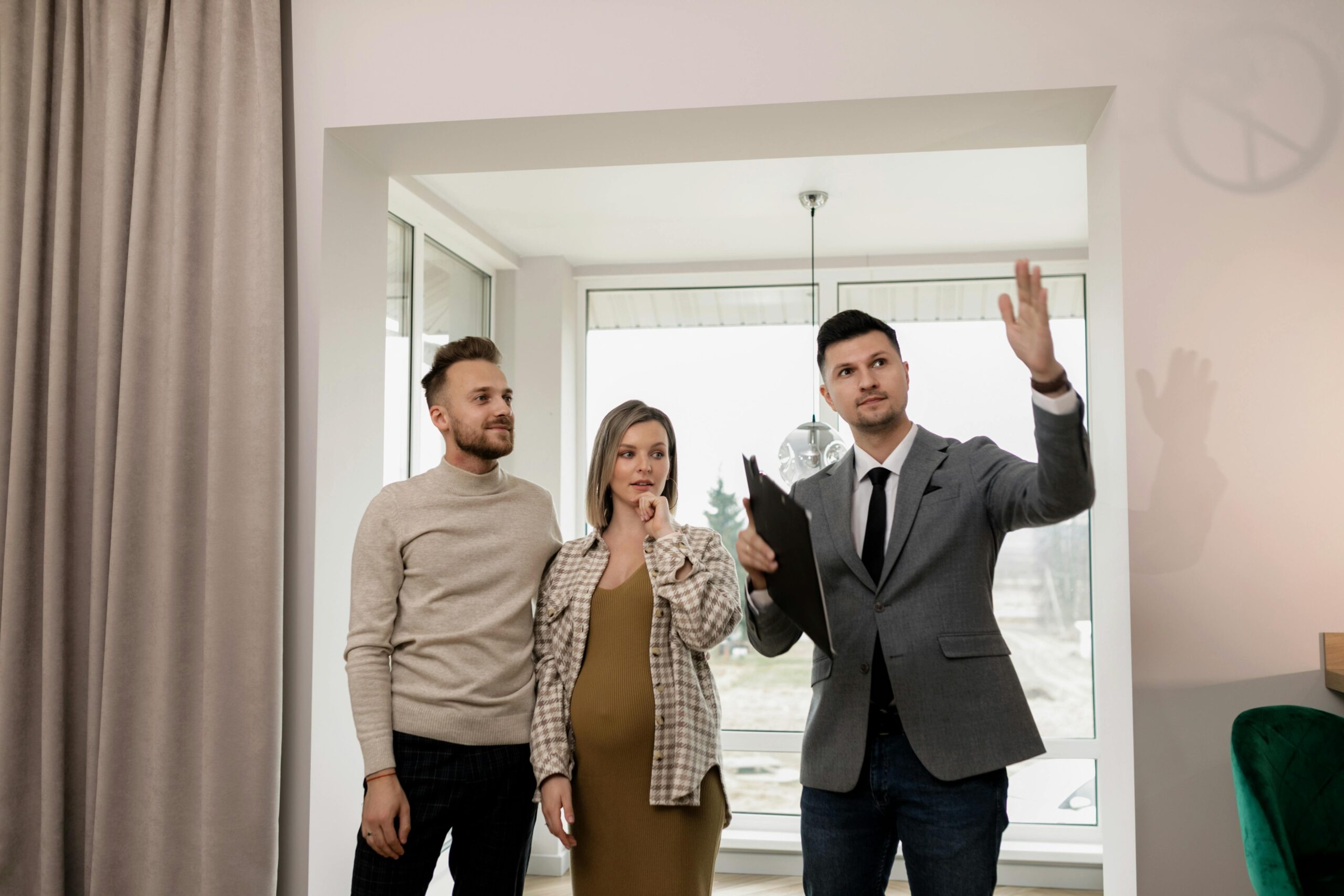 Real estate agent showing property to a couple during a home inspection